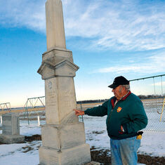 St. Johns Ridgely Cemetery board member Howard Roemer reads the inscription on the grave marker of Eda and Matilda Westphlen at the cemetery Wednesday, Jan. 9, 2013 near Scribner, Neb. Eda and Matilda perished in the Blizzard of 1888 while walking home fr