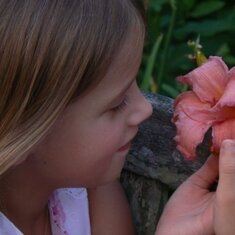 Christine smelling pappy's flowers