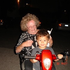 Cissi giving Tuvya a ride on her scooter in '06