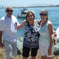 Gordon, Colleen, and Kim; Neptune Society boat in background.