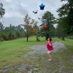 Deanna sending up balloons in memory of Grandma Cedar 2021