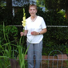 Liz with home grown Gladiola in back yard of Randolph Road home in Rockville, MD