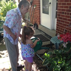 Granny with Betty Lewald.  Watering flowers in the front yard at 5103 Randolph Rd.