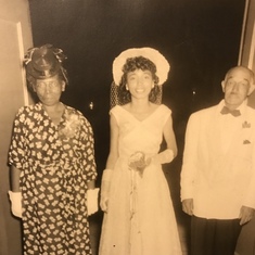 Emma, with her parents on her wedding day.