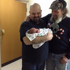 Big Ed and little Eddie with the new Baby. He is beautiful.
