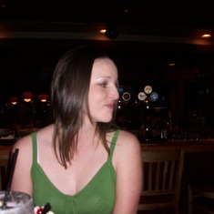 Erica on her 21st at Applebees.(trying to get a photo as like brushing her hair)