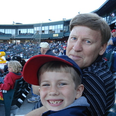 Tobias and grandpa making faces at the baseball game