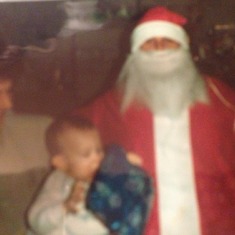 Uncle Errol being santa claus for the kids December 1986 with Petey