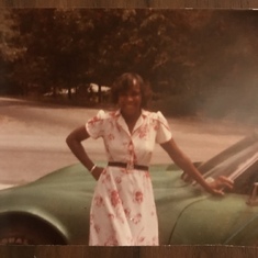 Mom posing with her green Corvette