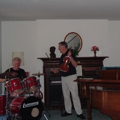 Friend Gerard Mundale on drums, Farren with violin, in his music room in Michigan. 