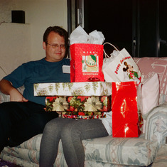 Forrest at my (Robin) mom's house in Phx. It's my Jewish wife's 1st Christmas--probably 2007 and she's happily buried in presents. Rare photo of Forrest without a beard.