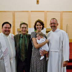 Fr. Rich, Deacon Don and the Moro family.