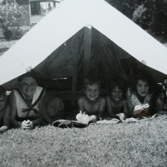 Fran with brothers & sisters in back yard tent