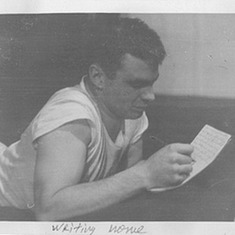 Dad writing a letter from a bunk at his overseas Post