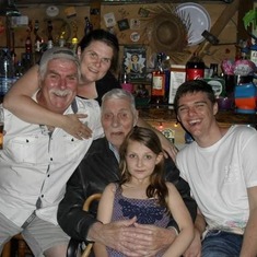 In the tiki bar in my garden with the grandchildren and great grandchildren