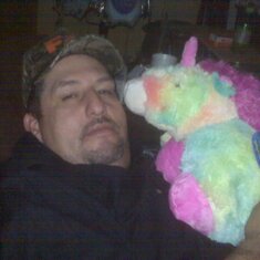 Frank holding his pillow pet.  Yes, it is a Unicorn....lol