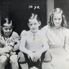 Dad on left holding puppy with Brother Bob and Sister Marie