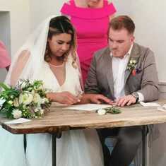 James & Abrielle signing their marriage documents