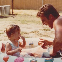 Daddy and I playing in my swimming pool...