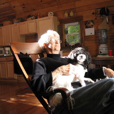 A favorite photo of her at our cabin in Hocking County, 2008. Sun on face, dog on lap. Happy.