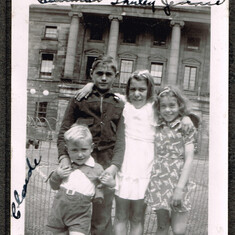 Claude Vessey in front, Freeman, Shirley and Jennie Vessey standing in front of orphanage