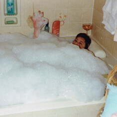 Mom waving as she is soaking in her big tub 2000