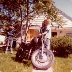Russ and George in my front yard, pondering how that old bike could still run.