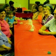 Family sitting at Table waiting to eat at George abbott's 82nd birthday in 2010