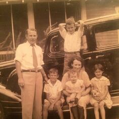 L-R: Father John, George age 8?, brother Jack standing, Mother Margaret holding Margie, and Marilyn, front yard of Henderson st home in Badin