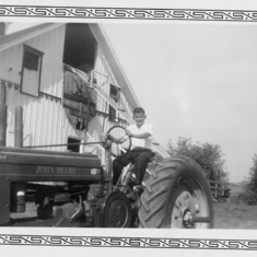 Gerry and tractor at the farm in Holton Kansas. Gerry gained an interest in mechanics at a young age.