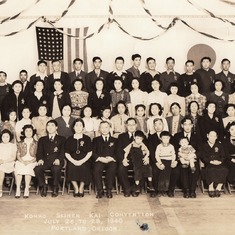 1940.  Formal photograph at an event sponsored by the Konko-Kyo Church of Seattle Washington.  The background is a sad reminder that war was about to break out between the United States and Japan…