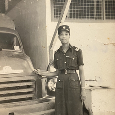 GranGran in front of a work car in her police uniform