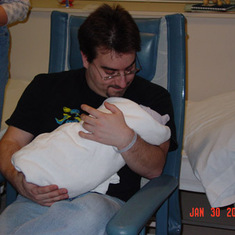 Greg holding his newborn daughter Kira for the first time.