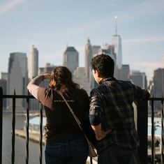 Tori & Gregory, looking out to Lower Manhattan from Brooklyn Heights. February 2017.