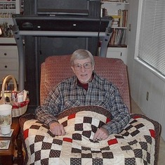 Harry resting at home with a blanket made by his daughter Ann.