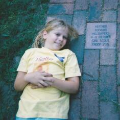 Amy by Heather's memorial brick at Bruemmer Park donated by Girl Scout Troop 252.
