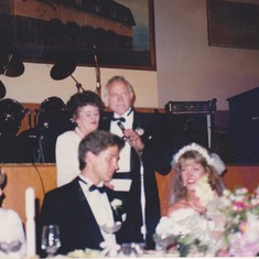mom and dad singing at our wedding