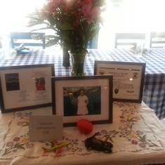 Memorial table with photos and souvenirs of Lily's hobbies at the dinner following the memorial service.