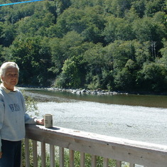 Helen on the back deck of their house in Brookings, Oregon called 'River Run'. The Chetco River in the background