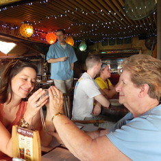 Showing pictures to Stacia at La Mariana in Honolulu, 2012