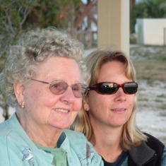 Sue with her Mum, watching a beach sunset