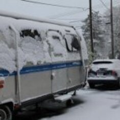 Trailer in snow.  There she sat, all winter long, longing for the return of the Van so she could travel again!