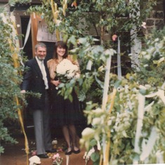 the newly weds at home in an arbour walkway decorated by friends with streamers in the German national colours. Unfortunately, with the rain, they looked just like wet toilet paper --- die Jungvermählten zu Hause in einem Laubengang, der von Freunden mit 
