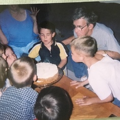 My grandkids helping Hilbert  blow out his candles on his birthday cake!!!!