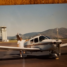 Tom with his Piper airplane on Kingsley Field in Klamath Falls Oregon. 1985. His first year as a Pil