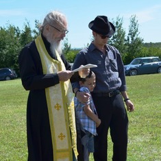 son-in-law Father John Bingham, great-grandson Makariy, and grandson Andrew