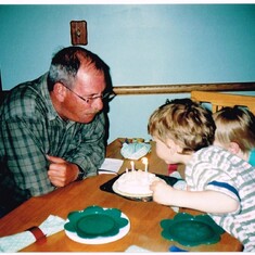 Blowing out his birthday cake candles with Andrew and Ian Visser's help - May 2003