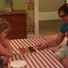 imogin playing checkers with jonathon.