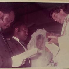 Dad and his bride in the early 80's being wedded in matrimony and by his Best Man- Uncle Henry 
