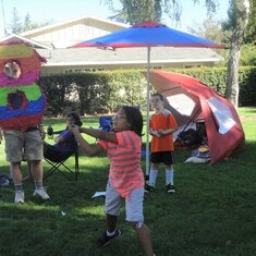 Showing the other kids how to properly crack open a pinata! 